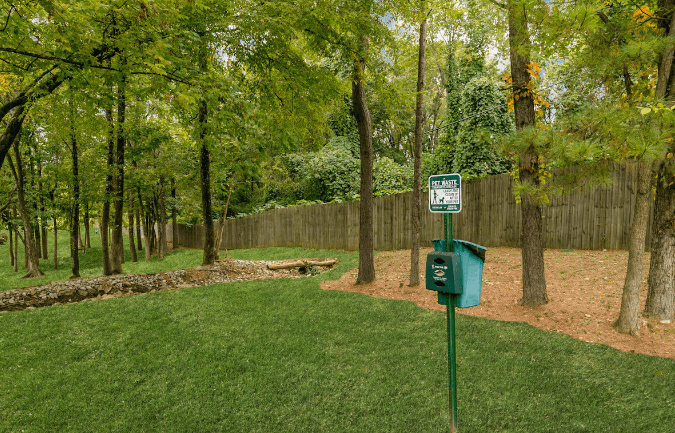 a picnic table sits in the middle at Crestwood Green, LLC, Birmingham, ALof a grassy area with a fence in the background at Crestwood Green, LLC, Birmingham, AL