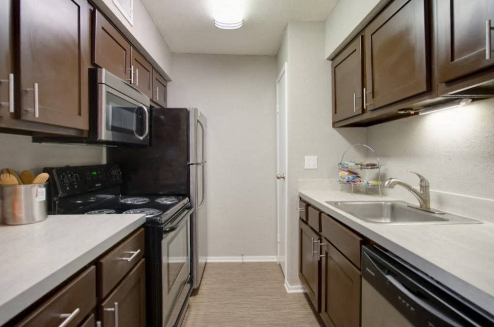 a kitchen with stainless steel appliances and wooden cabinets