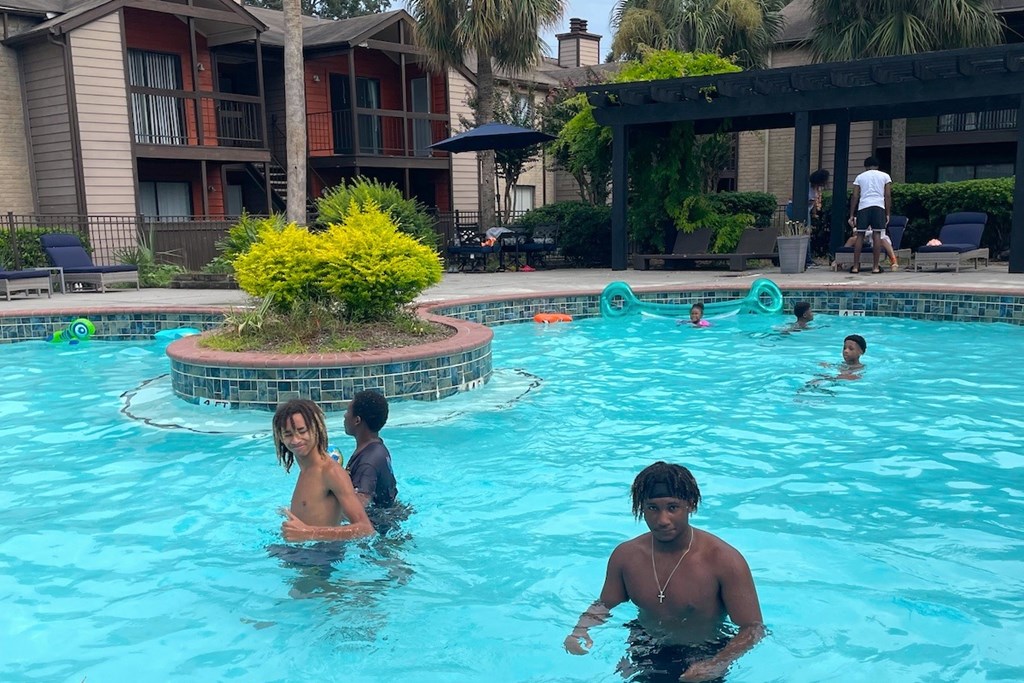 A group of people are enjoying a swim in a pool.