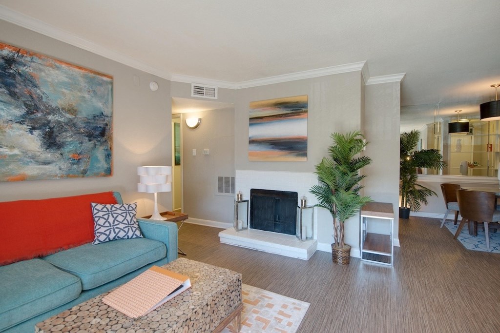 a living room with a fireplace and model furnishings at Hudson at Westchase Apartments