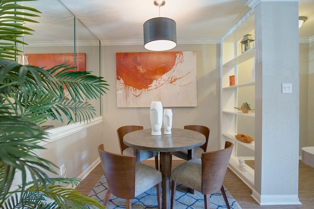 a dining room with built-in shelving and model furnishings in a home at Hudson at Westchase Apartments