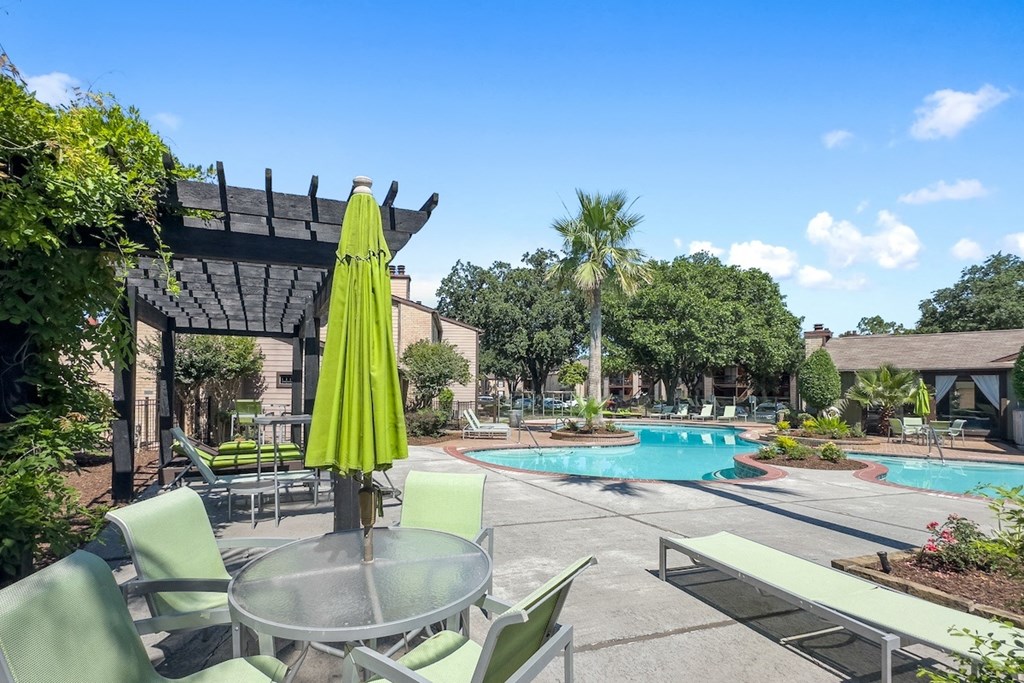 a patio with tables and chairs, a pergola, and a swimming pool at Hudson at Westchase