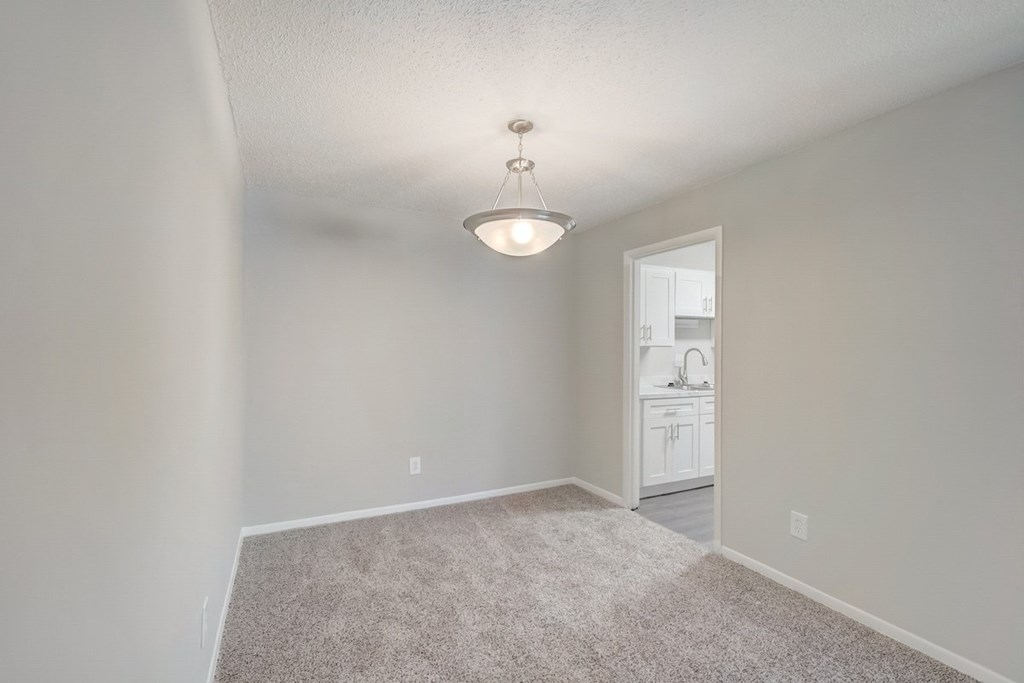 a dining room with a modern chandelier at Hills at Hoover 35216