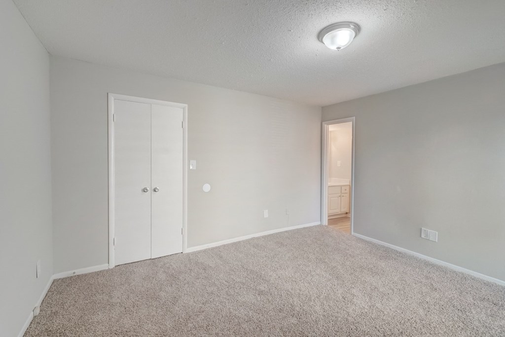 a bedroom with overhead lighting at Hills at Hoover Apartments 35216