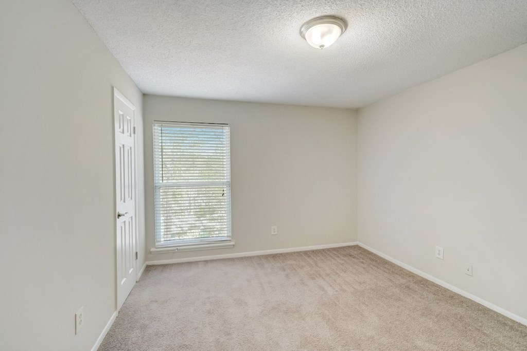 a bedroom with a ceiling light and large window at Hills at Hoover 35216