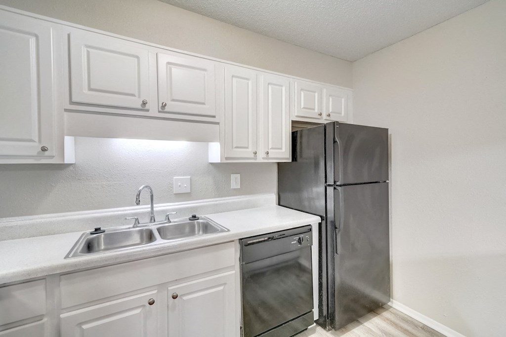 a modern, renovated kitchen with a dishwasher at Hills at Hoover 35216