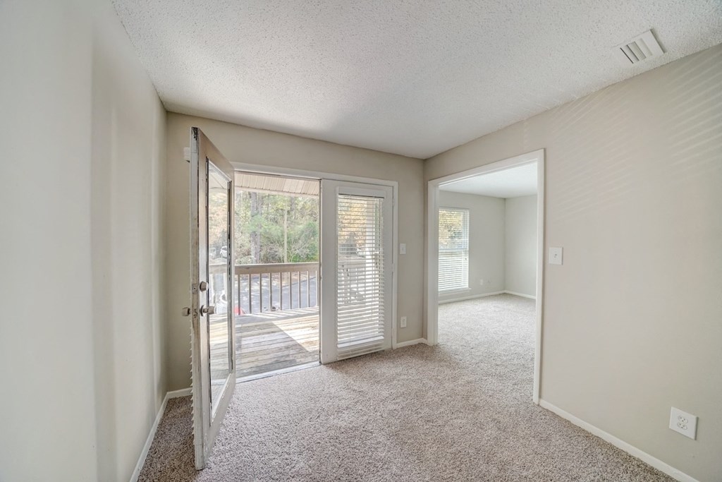 a spacious living room with french doors to a balcony at Hills at Hoover 35216