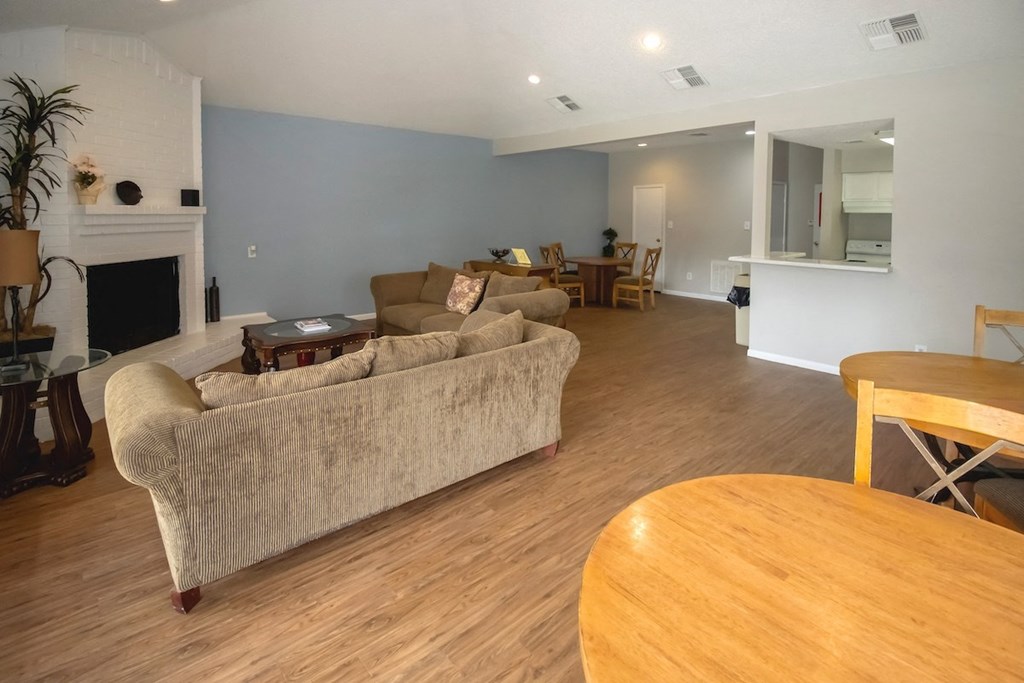 a resident lounge area with couch, fireplace, and kitchen in the Pine Creek clubhouse