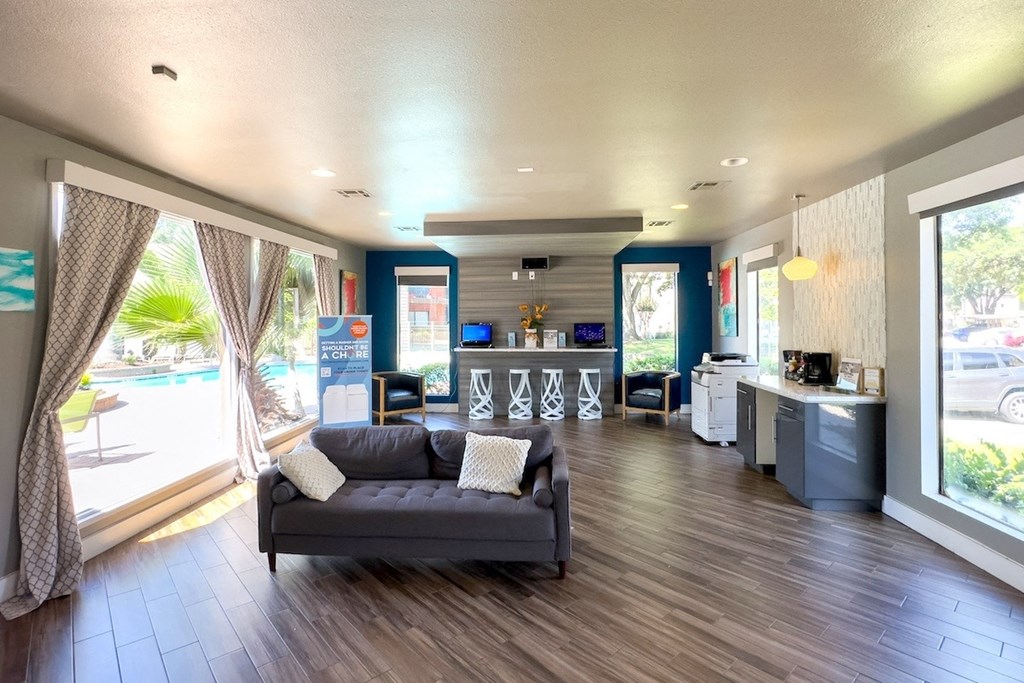 clubhouse with a couch, business center, and coffee bar at Hudson at Westchase Apartments