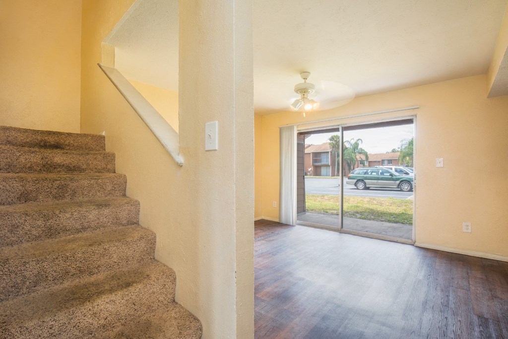 theoyer of a house with stairs and a door to the street