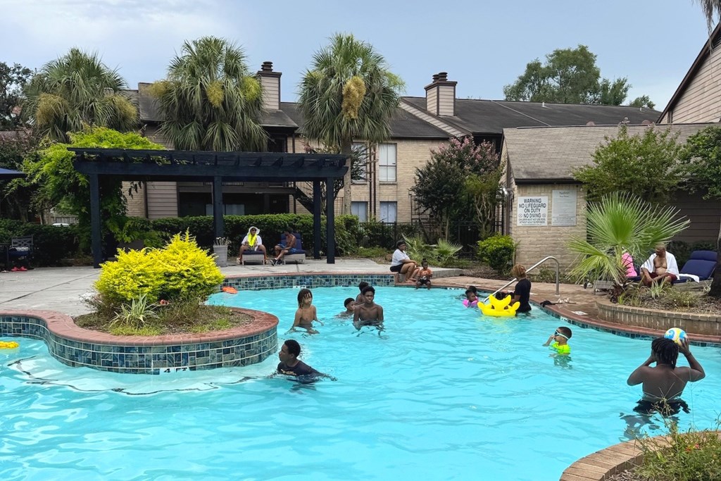 A group of people are enjoying a swim in a pool.
