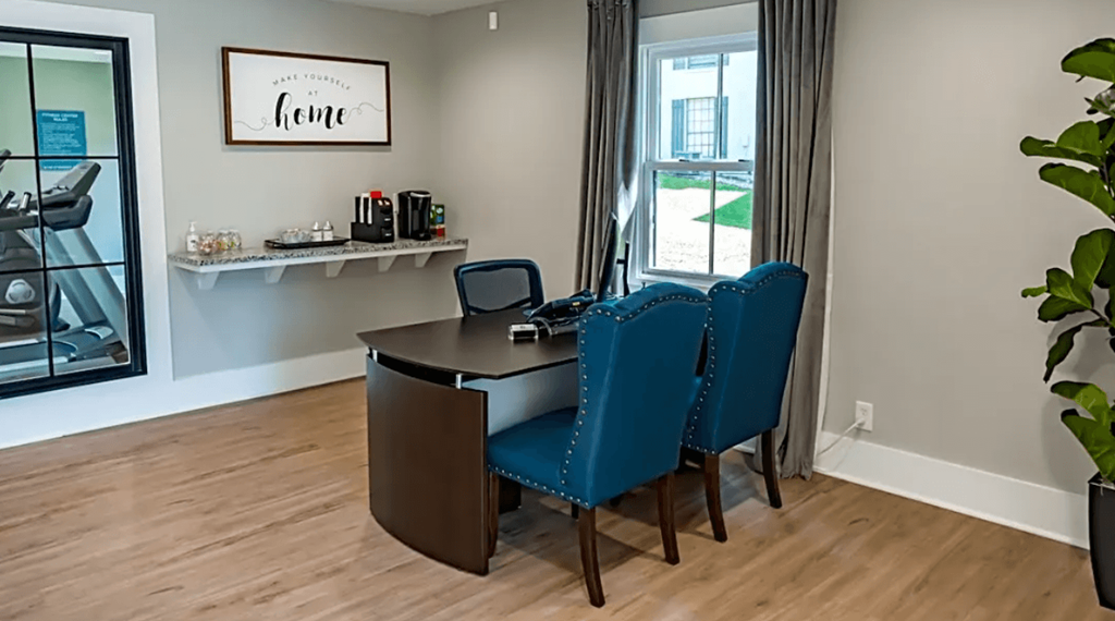 a room with a desk and chairs with a window in the background at Crestwood Green, LLC, Birmingham Alabama