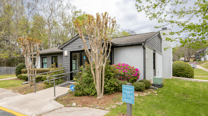 a gray building with a blue sign in front of it at Crestwood Green, LLC, Birmingham, AL 35212
