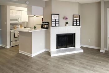 A kitchen with a white island and a fireplace.