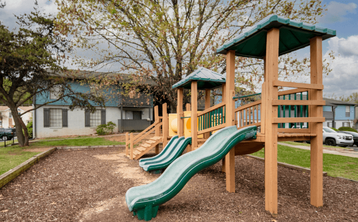 a playground with two slides and a monkey bars at Crestwood Green, LLC, Birmingham