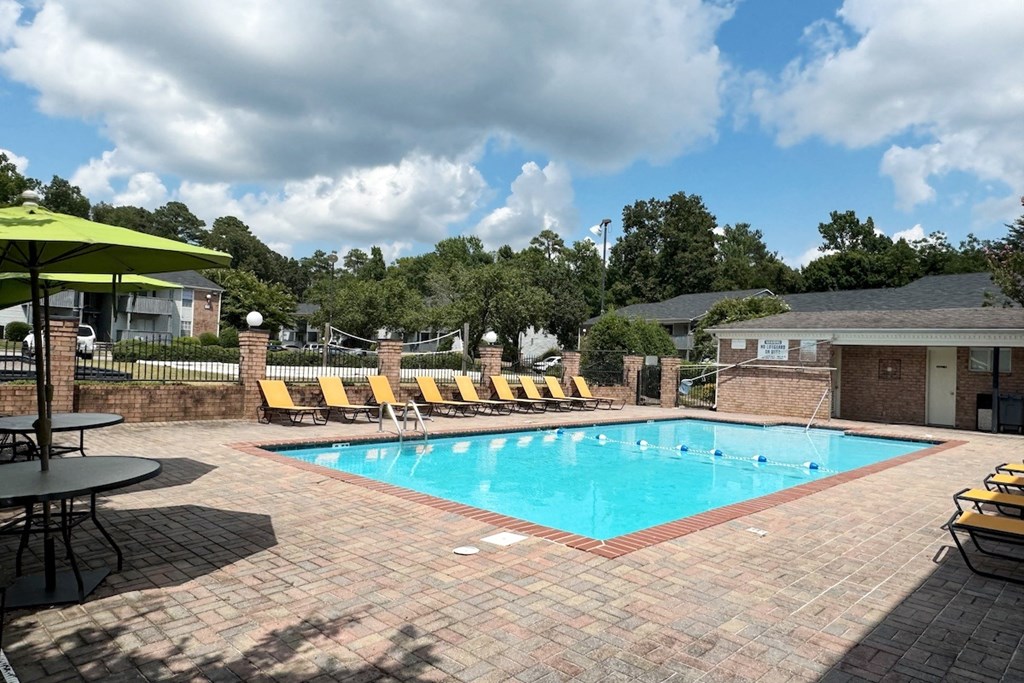 a swimming pool with yellow lounge chairs around it a swimming pool with yellow lounge chairs around it at Ascot Place Apartments, Alabama, 35235