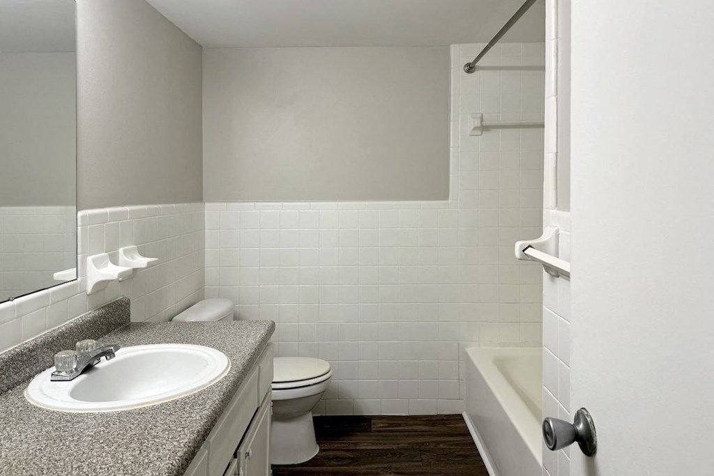 a bathroom with a sink toilet and a bath tub a bathroom with a sink toilet and a bath tub at Spring Lake Cove Apartments, Birmingham, 35215