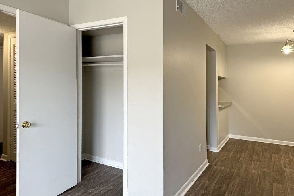 an empty room with a closet and a door open an empty room with a closet and a door open at Spring Lake Cove Apartments, Birmingham, 35215