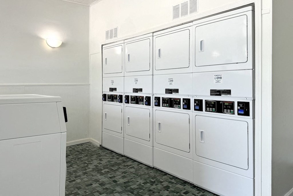 a row of white appliances in a laundry room a row of white appliances in a laundry room at Spring Lake Cove Apartments, Birmingham, AL 35215