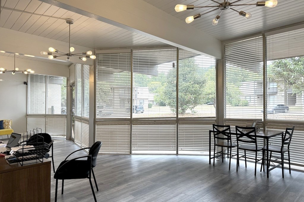 a dining room with windows and a table and chairs a dining room with windows and a table and chairs at Spring Lake Cove Apartments, Birmingham, 35215