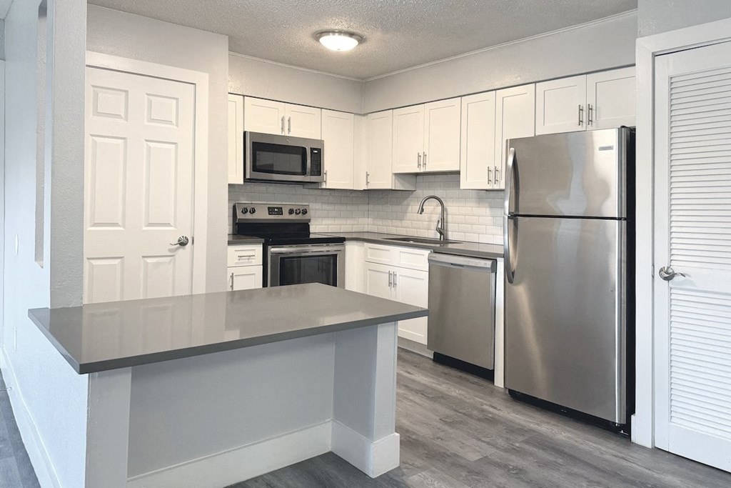 a kitchen with stainless steel appliances and white cabinets a kitchen with stainless steel appliances and white cabinets at Ascot Place Apartments, Alabama, 35235