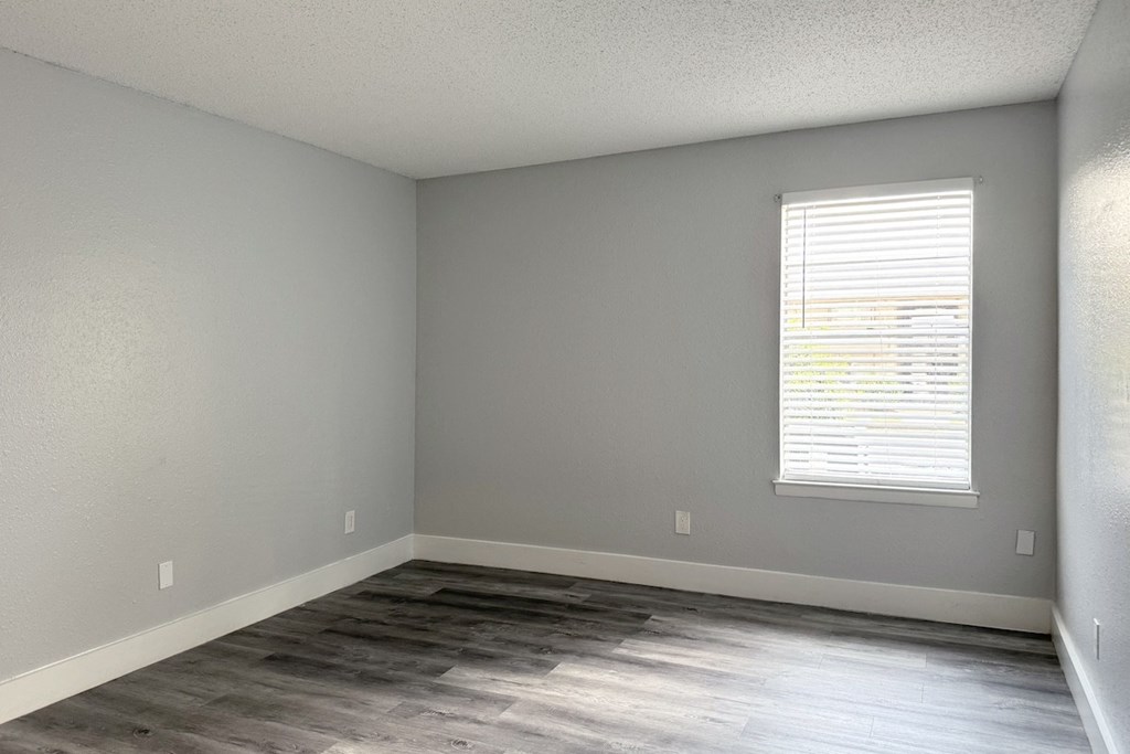 an empty room with wood floors and a window an empty room with wood floors and a window at Ascot Place Apartments, Birmingham