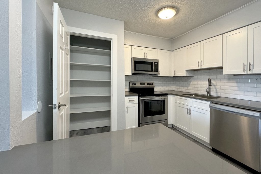 a kitchen with white cabinets and stainless steel appliances a kitchen with white cabinets and stainless steel appliances at Ascot Place Apartments, Birmingham, 35235
