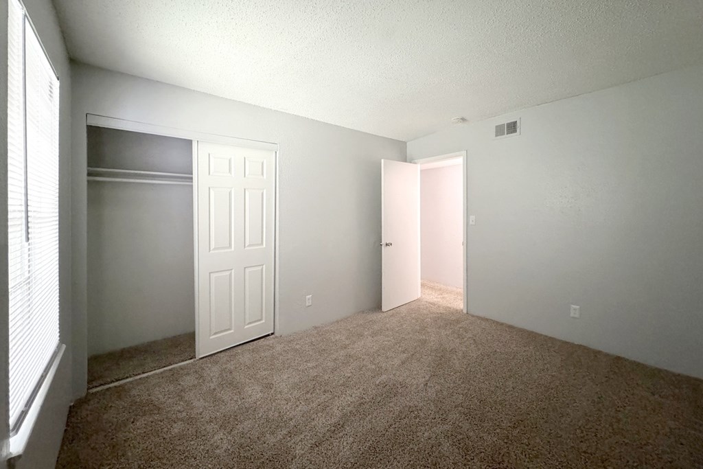 an empty bedroom with a closet and a white door an empty bedroom with a closet and a white door at Ascot Place Apartments, Alabama, 35235