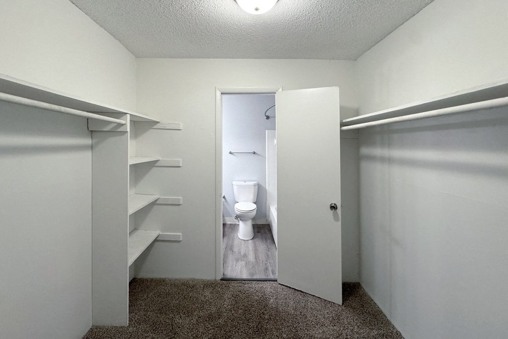 a bathroom with a toilet and a closet a bathroom with a toilet and a closet at Ascot Place Apartments, Birmingham, AL 35235