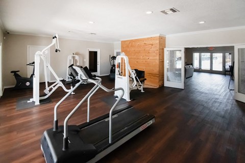 the fitness center with strength and cardio equipment at Winford Place