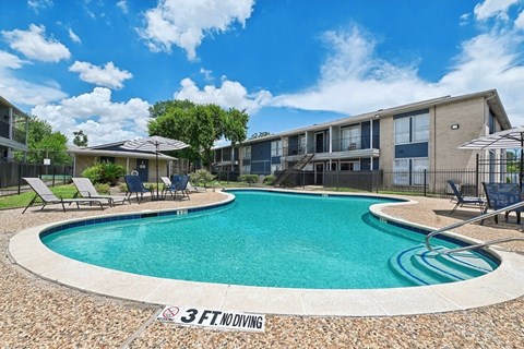A swimming pool with a 3 feet deep sign. at Pine Creek Apartments, Houston Texas