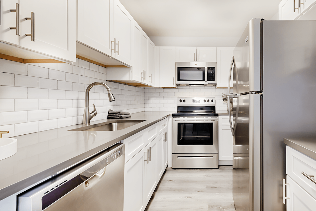 a modern kitchen with stainless steel appliances and white cabinets a modern kitchen with stainless steel appliances and white cabinets at Spring Lake Cove Apartments, Birmingham Alabama
