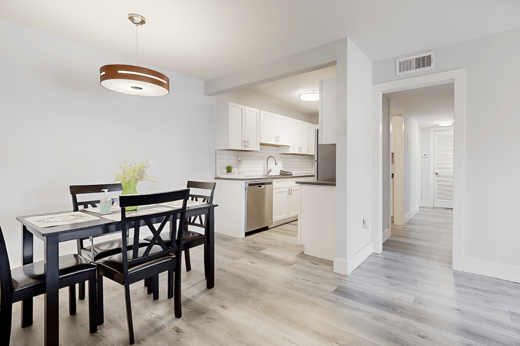 A large kitchen and dining room with wood-style floors and model furnishing A large kitchen and dining room with wood-style floors and model furnishing at Spring Lake Cove Apartments, Birmingham, AL