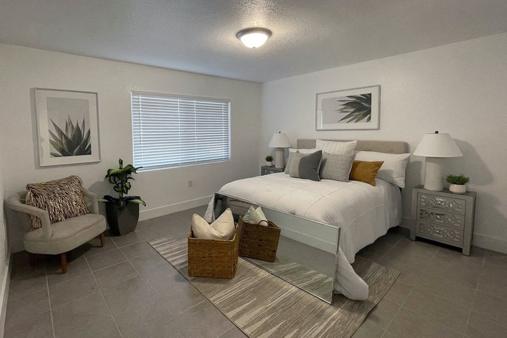 Serenity-Lake_PG-71 a model bedroom with a large window and tile floor at Serenity Lake Apartments