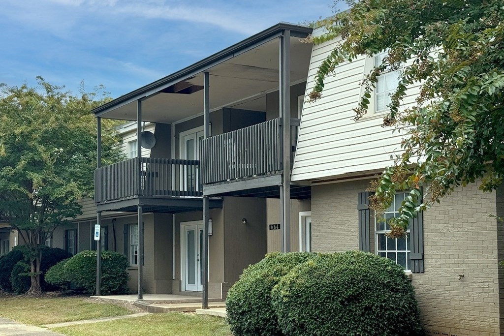 an apartment building with a balcony and trees an apartment building with a balcony and trees at Spring Lake Cove Apartments, Birmingham