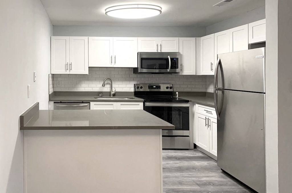 a kitchen with stainless steel appliances and white cabinets a kitchen with stainless steel appliances and white cabinets at Spring Lake Cove Apartments, Birmingham