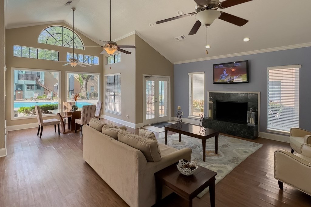 the spacious and welcoming clubhouse interior with furnishings and a tv at Waters at Westchase
