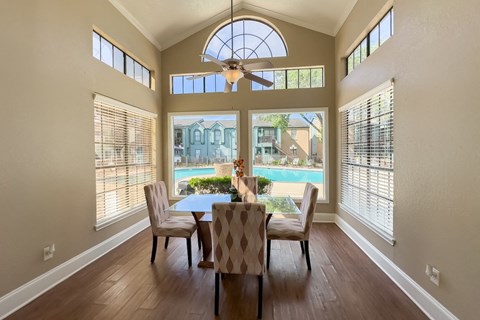 a dining area surrounded by windows overlooking the pool at Waters at Westchase