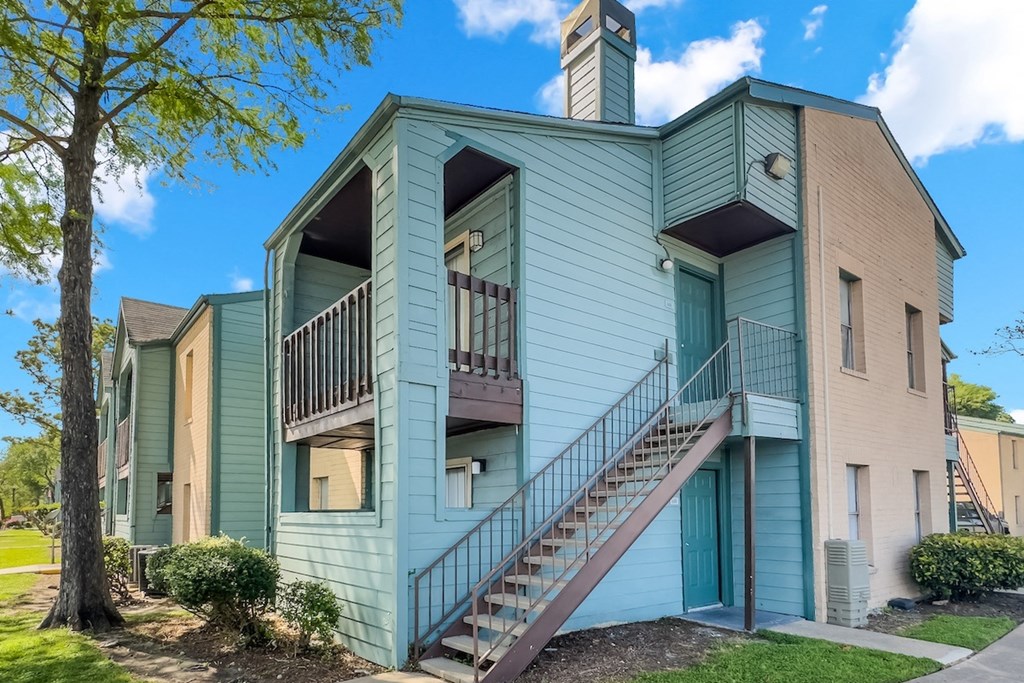 a residential apartment building with stairs at Waters at Westchase apartments in houston