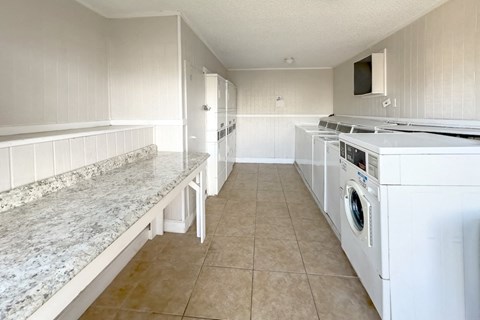 a kitchen with a counter top and a stove and a washing machine