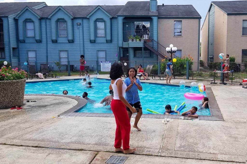 Two residents talking beside the pool at Waters at Westchase