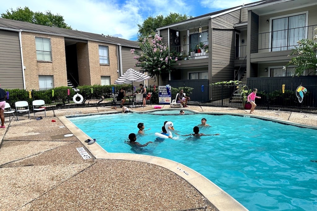 People are enjoying a sunny day at the pool.