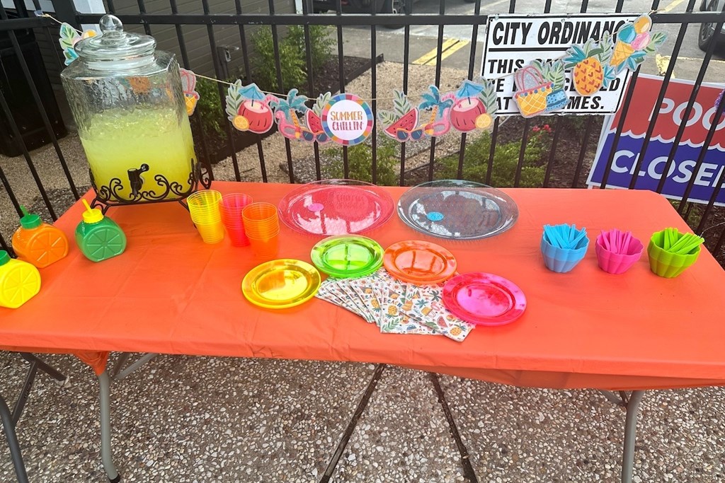 A table with a red tablecloth and various items on it.