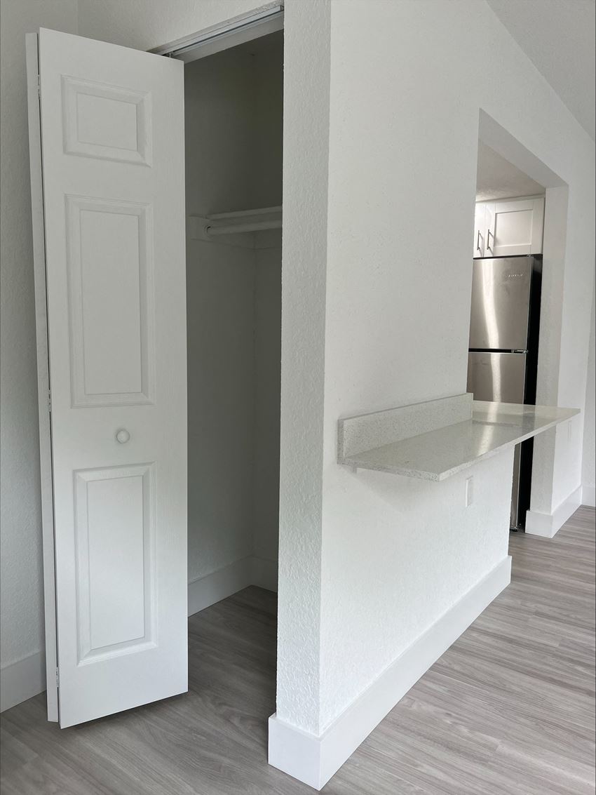 a bedroom with a large white door and a white shelf on the wall - Photo Gallery