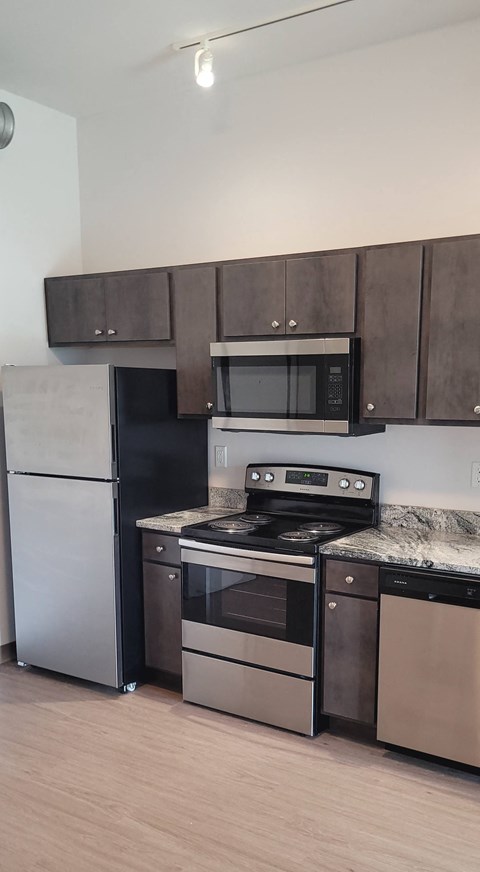 a kitchen with stainless steel appliances and a counter top