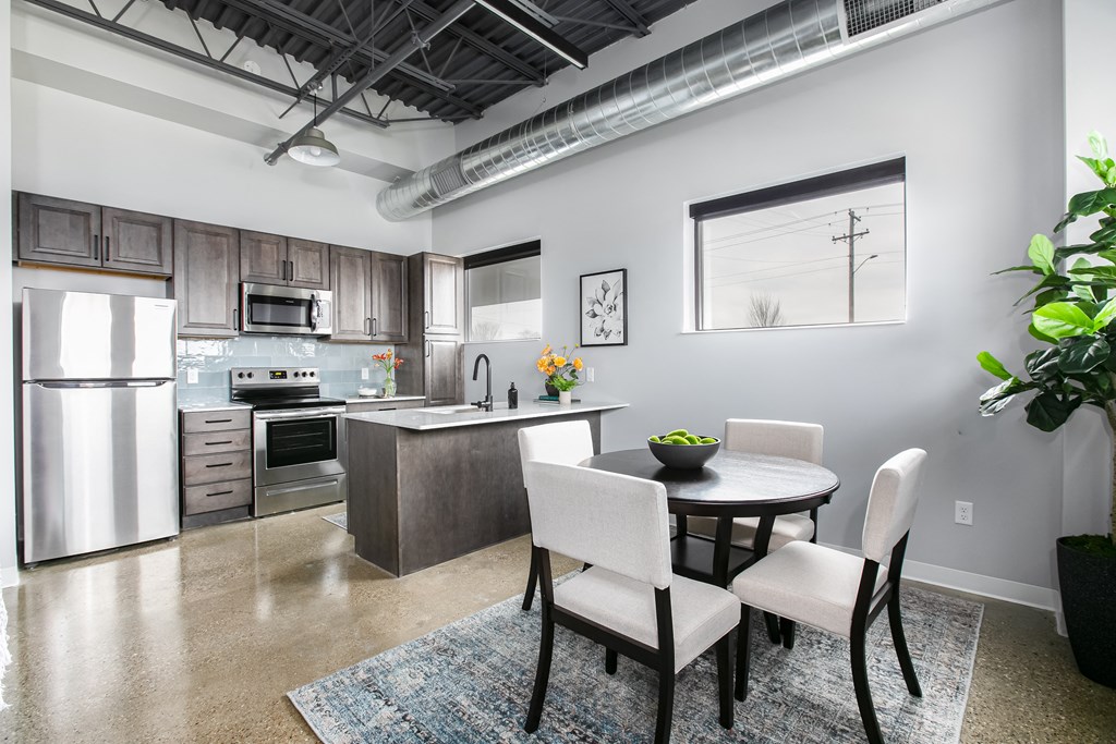 an open kitchen and dining room with a table and chairs