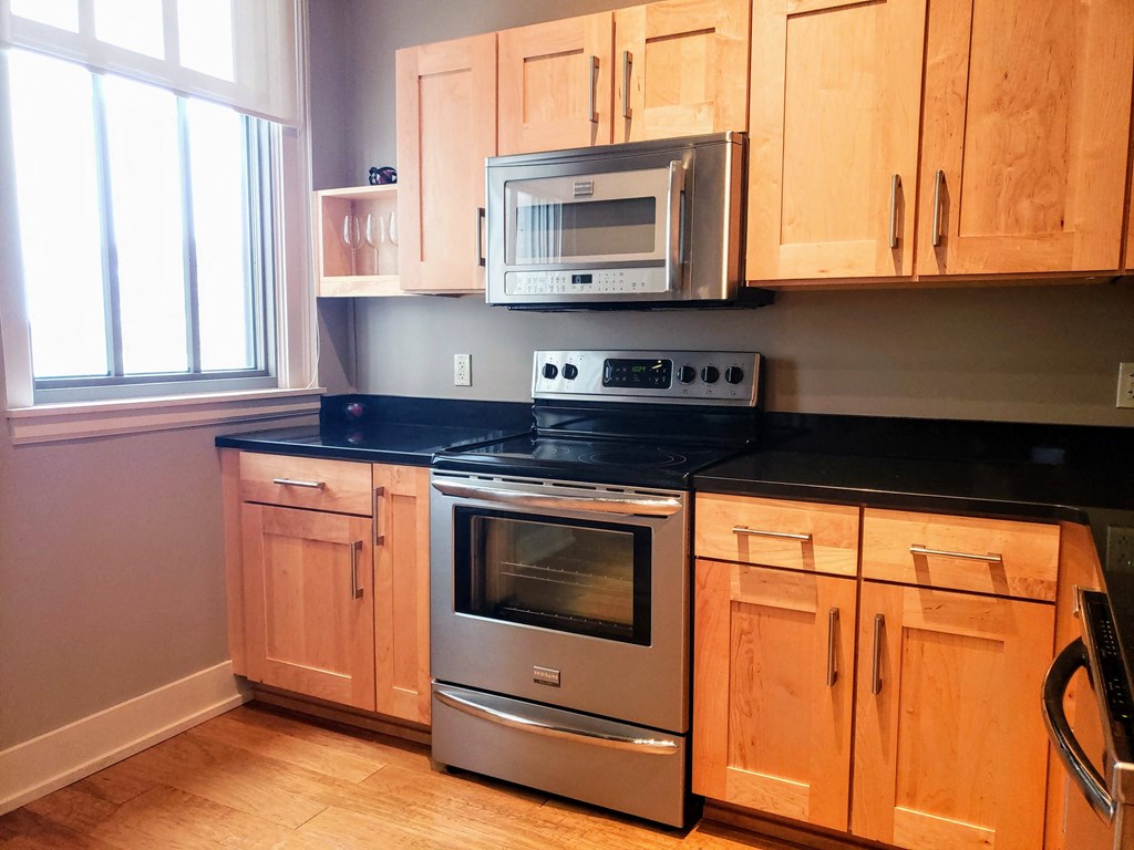 a kitchen with stainless steel appliances and wooden cabinets