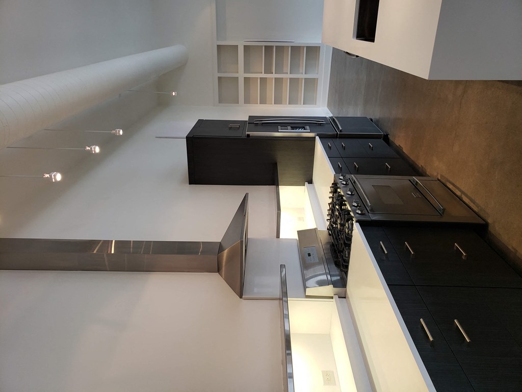 a view of the kitchen from the top of the stairs