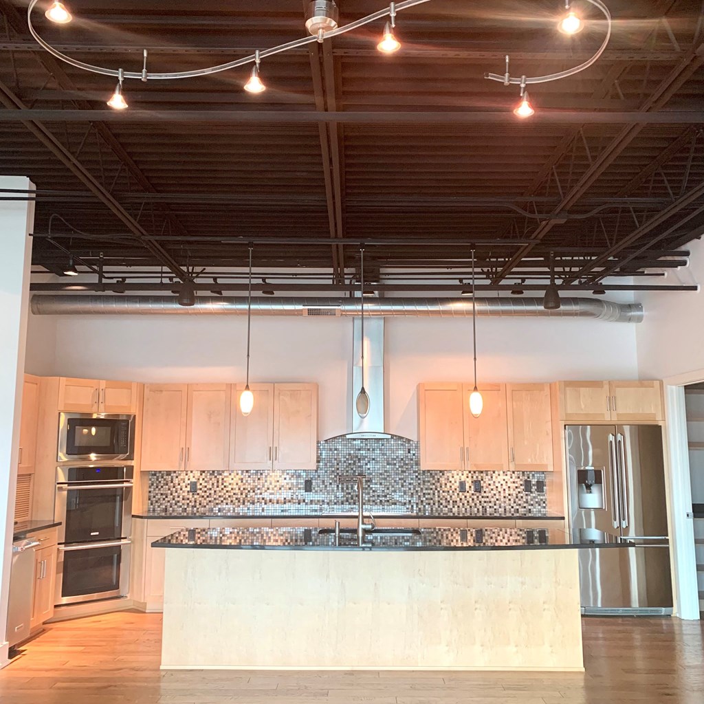 a large kitchen with a large island in the middle