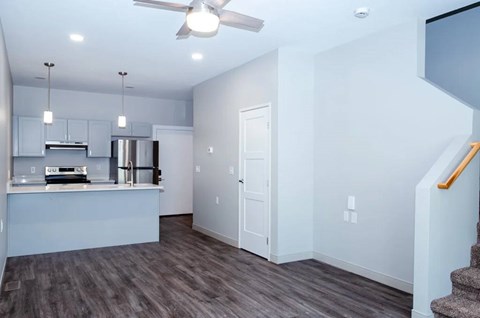 A kitchen with a stainless steel refrigerator and a ceiling fan.